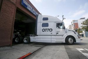 FILE - In this Aug. 18, 2016, file photo, one of Otto's self-driving, big-rig trucks leaves the garage for a test drive during a demonstration at the Otto headquarters in San Francisco. Anheuser-Busch announced on Oct. 25, 2016, that it teamed up with Otto for a 120-plus mile beer delivery that marked the world's first by a self-driving truck. (AP Photo/Tony Avelar, File)
